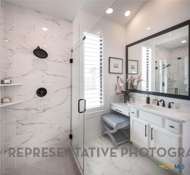 bathroom featuring vanity and an enclosed shower