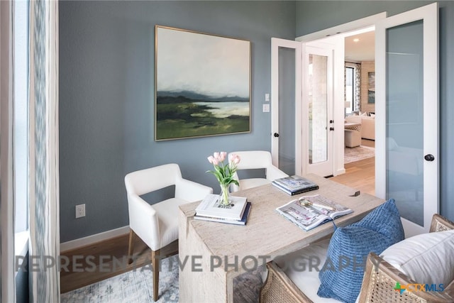 living area with french doors and light wood-type flooring