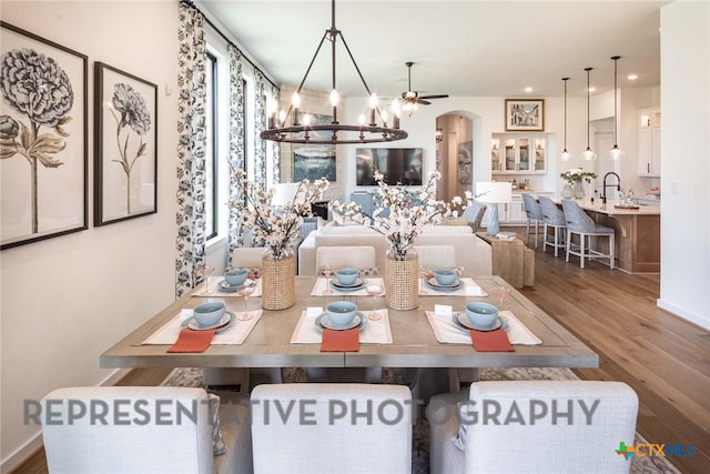 dining room with hardwood / wood-style floors and a notable chandelier