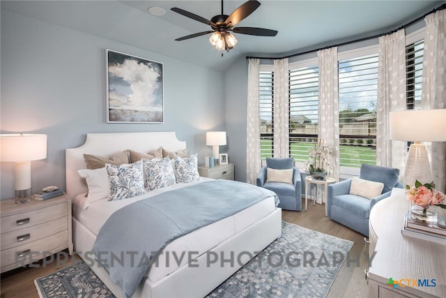 bedroom with multiple windows, ceiling fan, and light hardwood / wood-style flooring