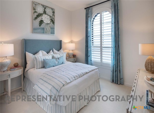 bedroom featuring light colored carpet