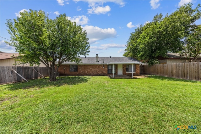 2310 Bunker Hill Dr, Temple, TX 76504 - back of house with a fenced backyard and brick siding