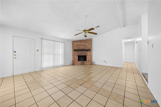 2310 Bunker Hill Dr, Temple, TX 76504 - unfurnished living room featuring ceiling fan, light tile patterned floors, a fireplace, and a textured ceiling