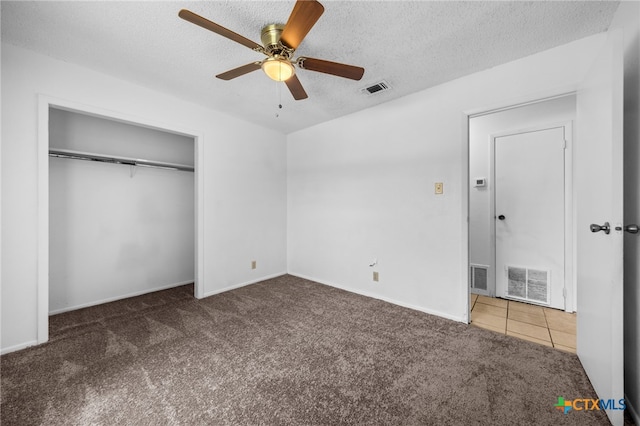 2310 Bunker Hill Dr, Temple, TX 76504 - unfurnished bedroom with carpet, a textured ceiling, a closet, and ceiling fan