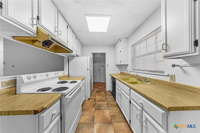 2310 Bunker Hill Dr, Temple, TX 76504 - kitchen featuring white appliances, a textured ceiling, white cabinetry, stone finish flooring, and light countertops