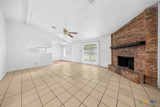 2310 Bunker Hill Dr, Temple, TX 76504 - unfurnished living room with a ceiling fan, a fireplace, light tile patterned flooring, and a textured ceiling