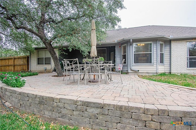 back of house with a patio area, brick siding, and fence