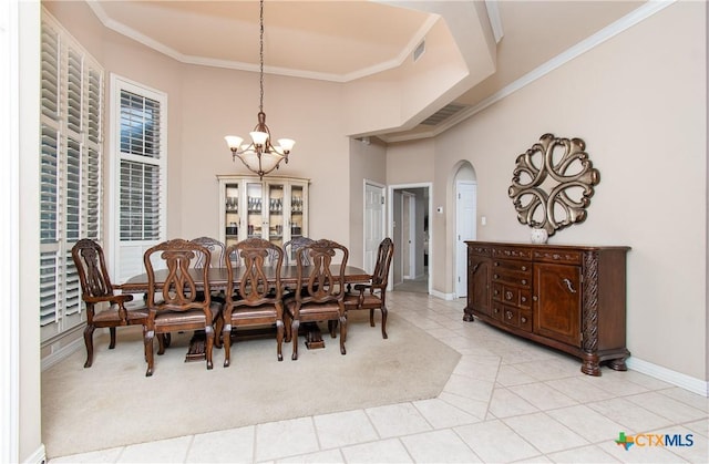 dining space with arched walkways, light tile patterned floors, visible vents, ornamental molding, and a chandelier