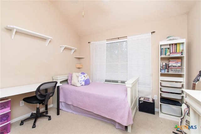 bedroom featuring lofted ceiling, light carpet, and baseboards