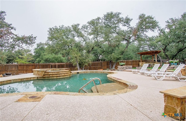 view of pool with a gazebo, a fenced backyard, a pool with connected hot tub, and a patio