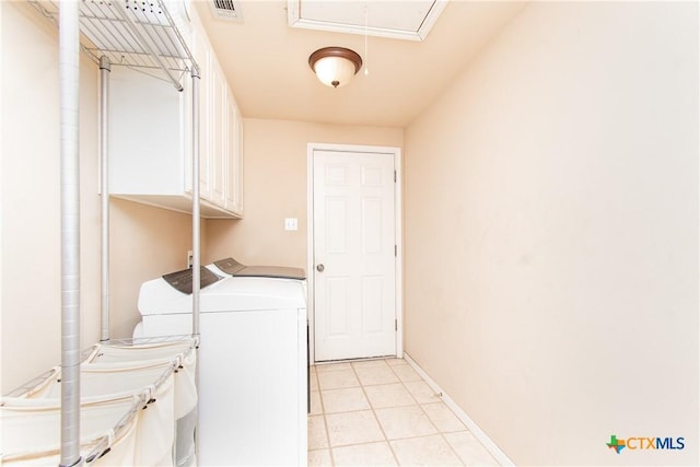 clothes washing area with light tile patterned floors, cabinet space, visible vents, attic access, and washing machine and dryer