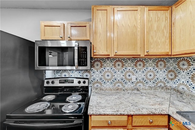 kitchen with range with electric cooktop, stainless steel microwave, light stone countertops, light brown cabinets, and backsplash