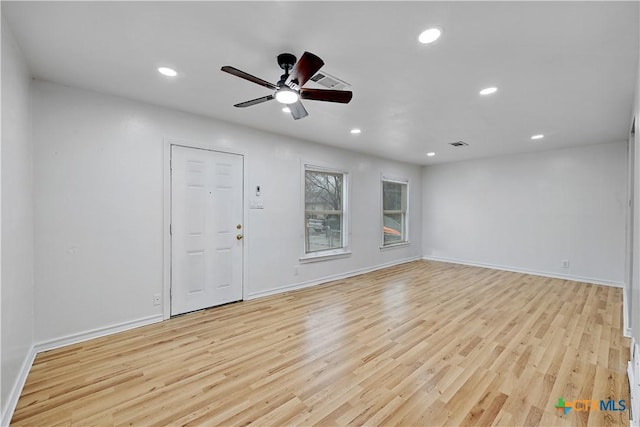 interior space with light wood-type flooring, baseboards, and recessed lighting