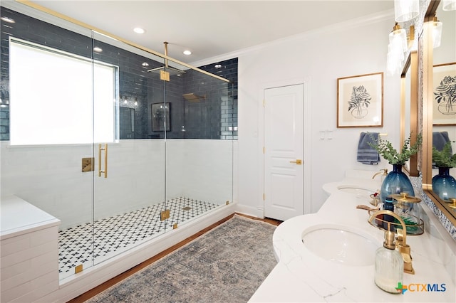 bathroom with walk in shower, ornamental molding, hardwood / wood-style flooring, and vanity