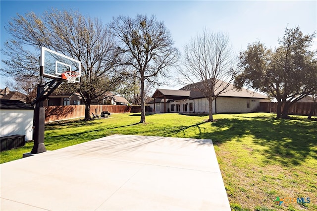 view of basketball court featuring a yard