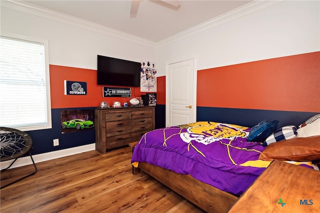 bedroom featuring hardwood / wood-style floors, ceiling fan, multiple windows, and crown molding