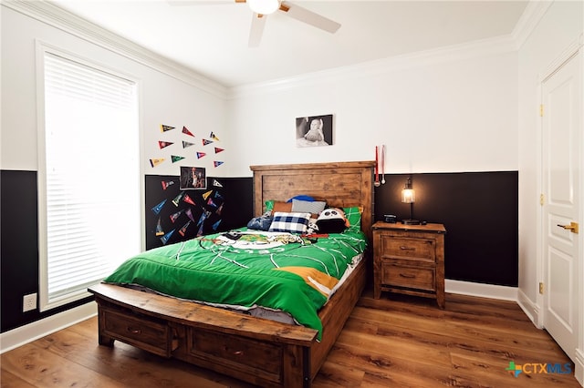 bedroom featuring hardwood / wood-style floors, ceiling fan, and crown molding