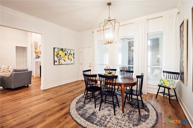 dining space featuring ornamental molding, hardwood / wood-style floors, and a healthy amount of sunlight