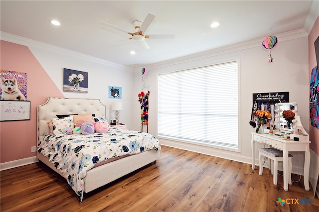 bedroom featuring hardwood / wood-style flooring, ceiling fan, and crown molding