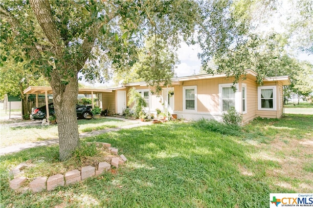 ranch-style house with a carport and a front yard