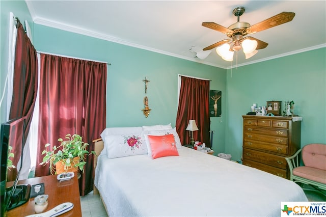 bedroom with ceiling fan and ornamental molding