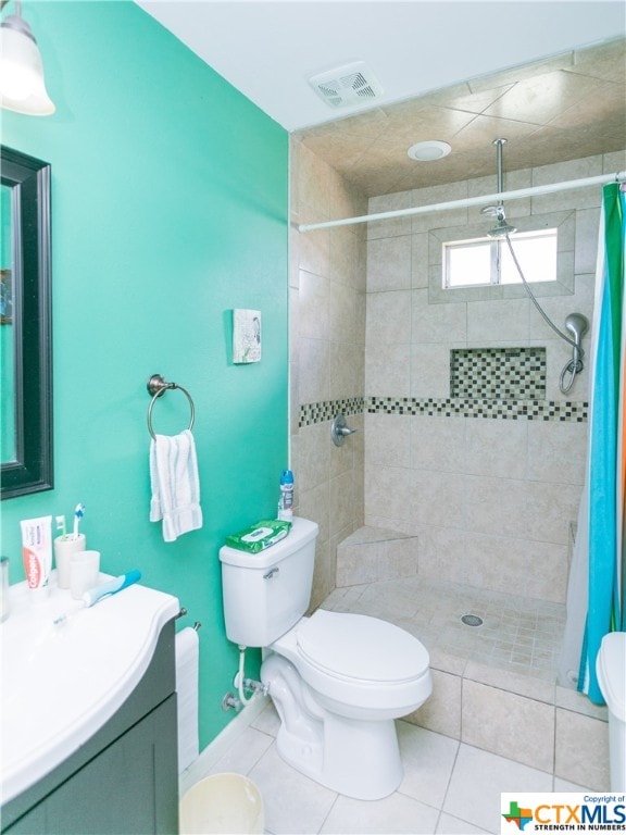 bathroom featuring walk in shower, tile patterned flooring, vanity, and toilet