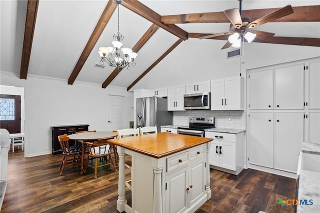 301 King Arthur St, Victoria, TX 77904 - kitchen featuring appliances with stainless steel finishes, decorative backsplash, beam ceiling, a ceiling fan, and white cabinets