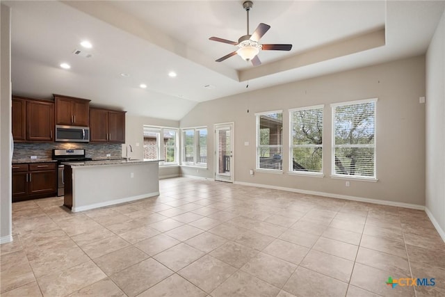 8113 Cannon Ct, Lago Vista, TX 78645 - kitchen featuring appliances with stainless steel finishes, decorative backsplash, open floor plan, light tile patterned flooring, and recessed lighting