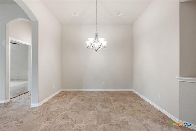 8113 Cannon Ct, Lago Vista, TX 78645 - unfurnished room featuring arched walkways, a chandelier, and light stone finish floors