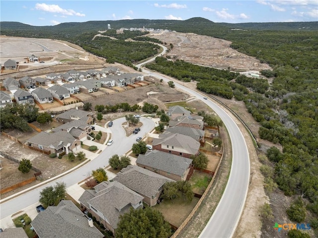 8113 Cannon Ct, Lago Vista, TX 78645 - aerial overview of property's location with nearby suburban area and a mountainous background