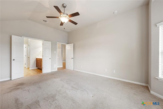8113 Cannon Ct, Lago Vista, TX 78645 - unfurnished bedroom featuring lofted ceiling, light colored carpet, ensuite bath, and ceiling fan