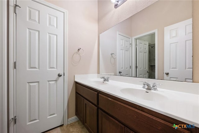 8113 Cannon Ct, Lago Vista, TX 78645 - bathroom with double vanity, tile patterned floors, and a shower
