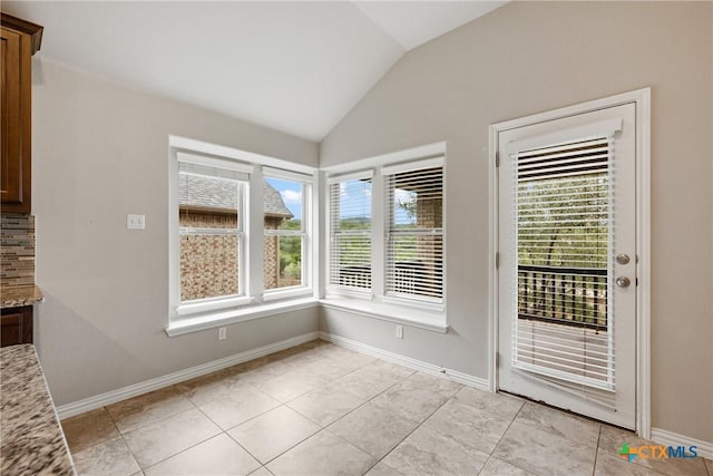 8113 Cannon Ct, Lago Vista, TX 78645 - unfurnished dining area with vaulted ceiling and light tile patterned floors