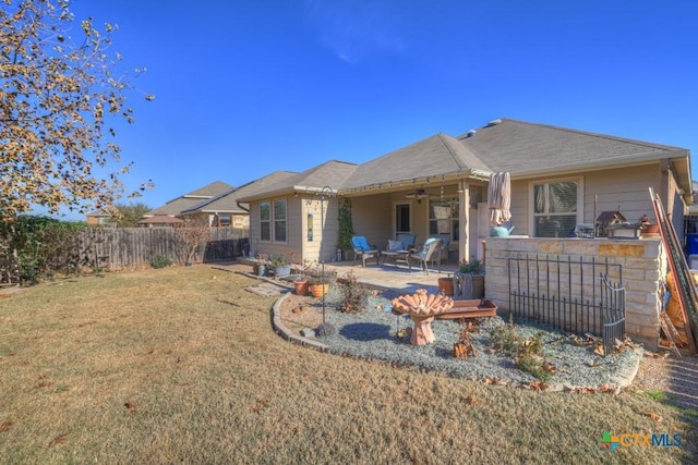 back of property featuring ceiling fan, a yard, an outdoor bar, and a patio area