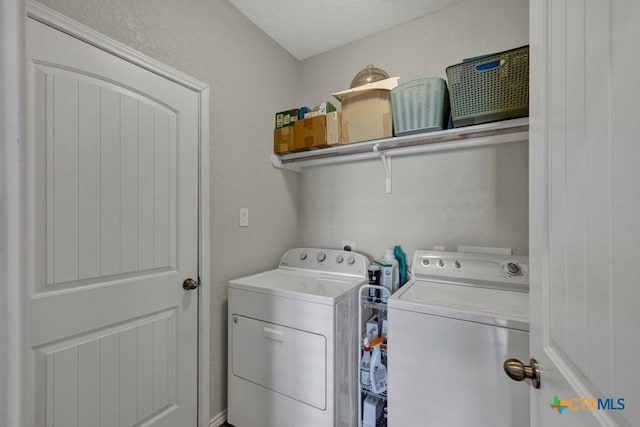 washroom featuring separate washer and dryer and a textured ceiling