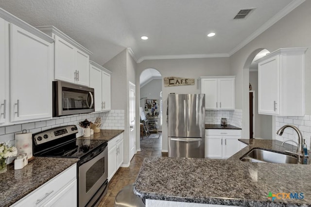 kitchen featuring white cabinetry, appliances with stainless steel finishes, sink, and tasteful backsplash