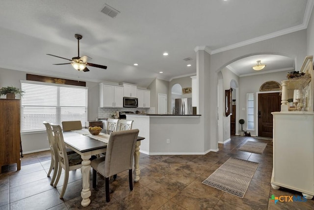 dining space featuring crown molding and ceiling fan