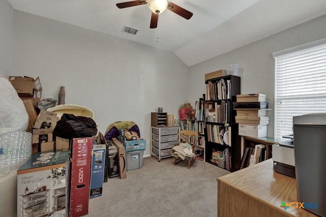 carpeted home office with ceiling fan and lofted ceiling