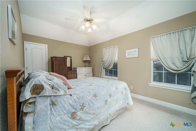 bedroom with carpet floors, vaulted ceiling, baseboards, and a ceiling fan