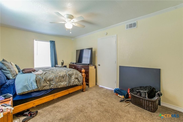 bedroom featuring carpet floors, ceiling fan, and crown molding