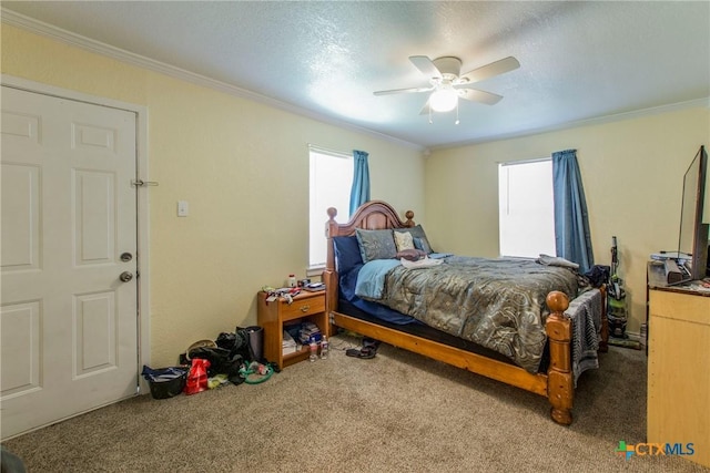 bedroom featuring carpet, a textured ceiling, ceiling fan, and ornamental molding