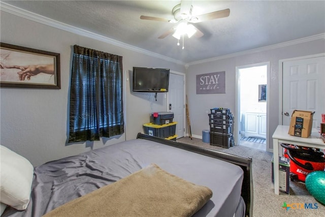 carpeted bedroom featuring ensuite bathroom, ceiling fan, and ornamental molding