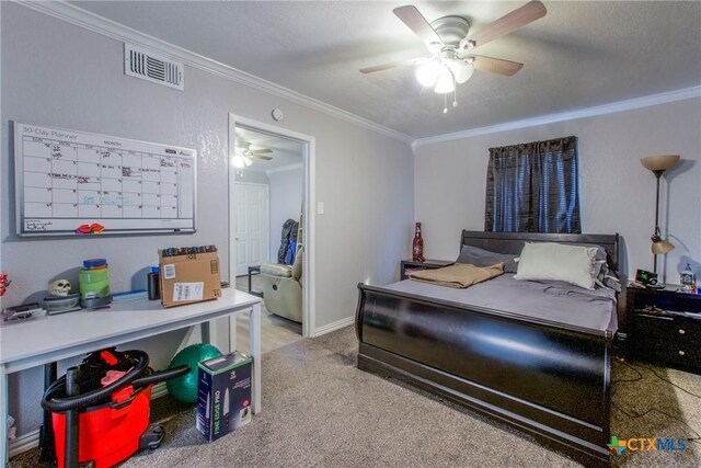 carpeted bedroom with ceiling fan, crown molding, and a textured ceiling