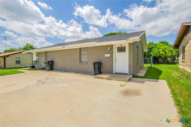 back of property with a yard and a patio area