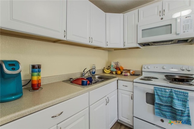 kitchen with white cabinets, white appliances, and sink