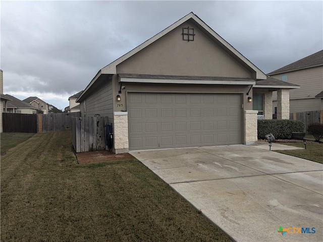 view of front of property with a front yard and a garage