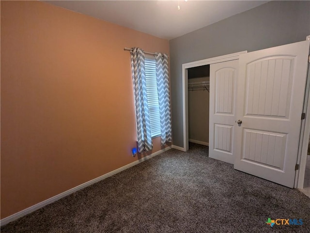 unfurnished bedroom featuring carpet flooring and a closet