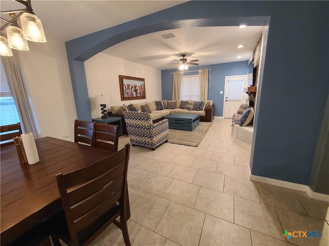 living room with ceiling fan and light tile patterned floors