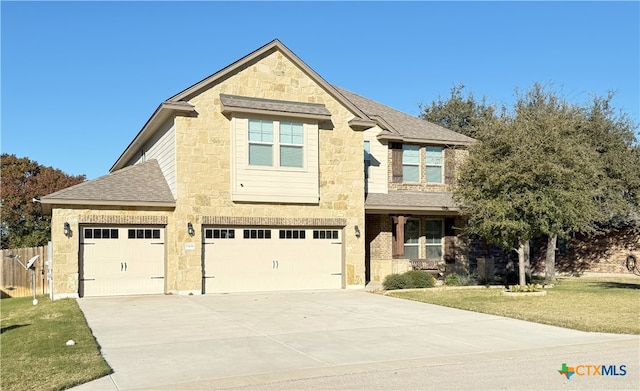 craftsman house with a front lawn and a garage