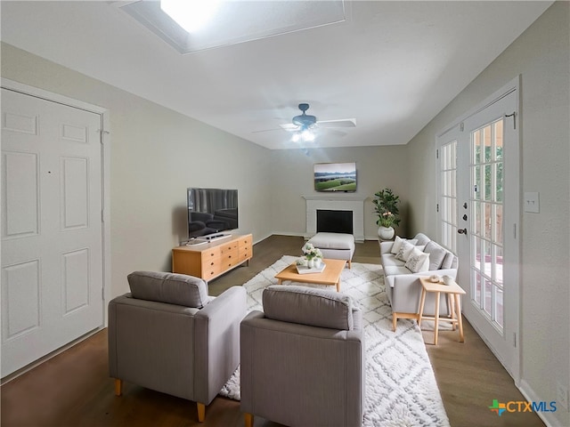 living room featuring dark hardwood / wood-style flooring, french doors, and ceiling fan